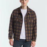 Man wearing a plaid shirt over a white t-shirt on a white background