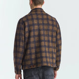 Man wearing a plaid shirt from behind on a white background