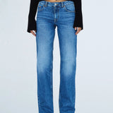 Person wearing blue jeans on a white background