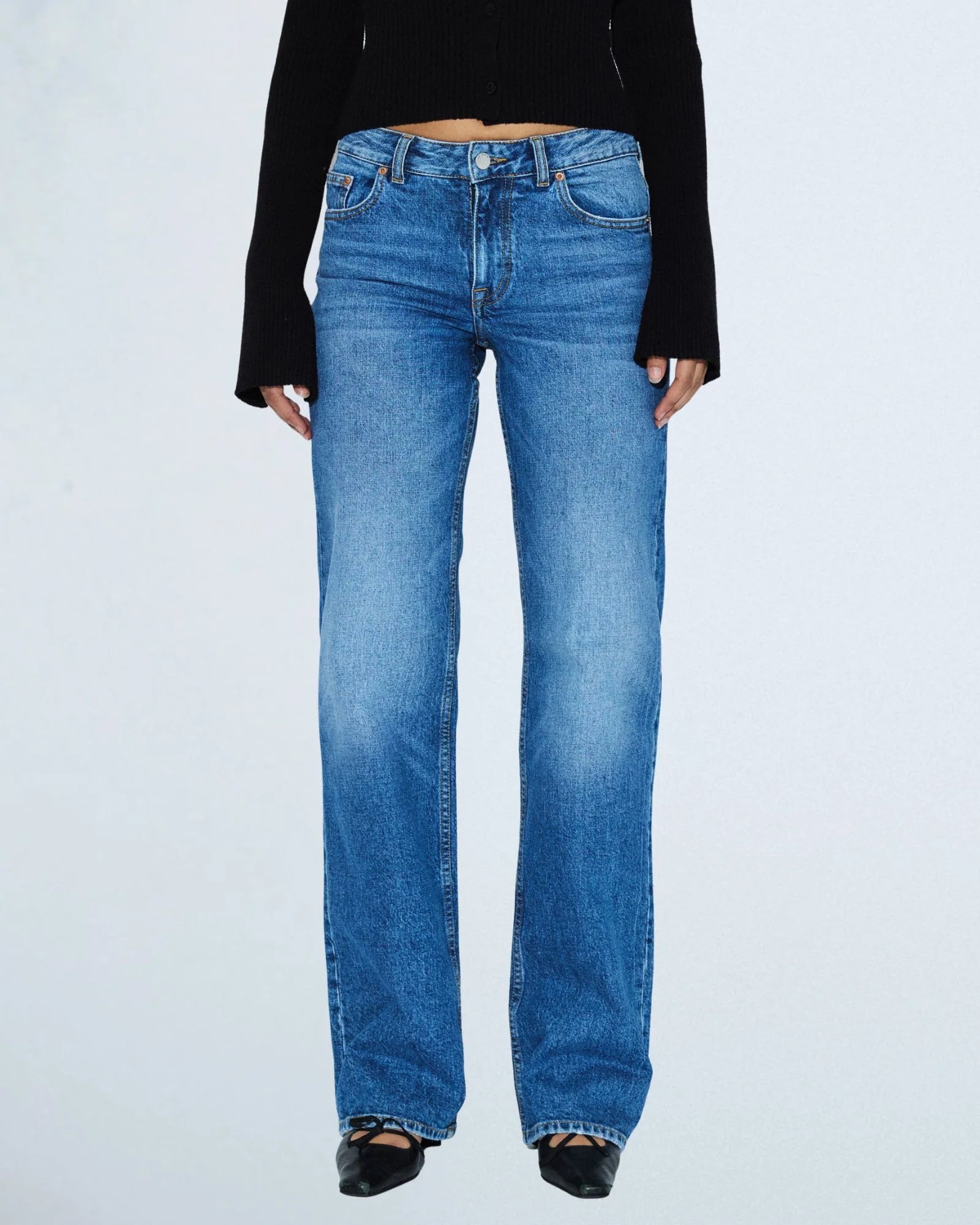 Person wearing blue jeans on a white background