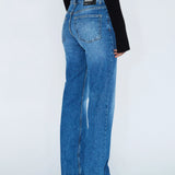 Blue jeans worn by a person on a white background