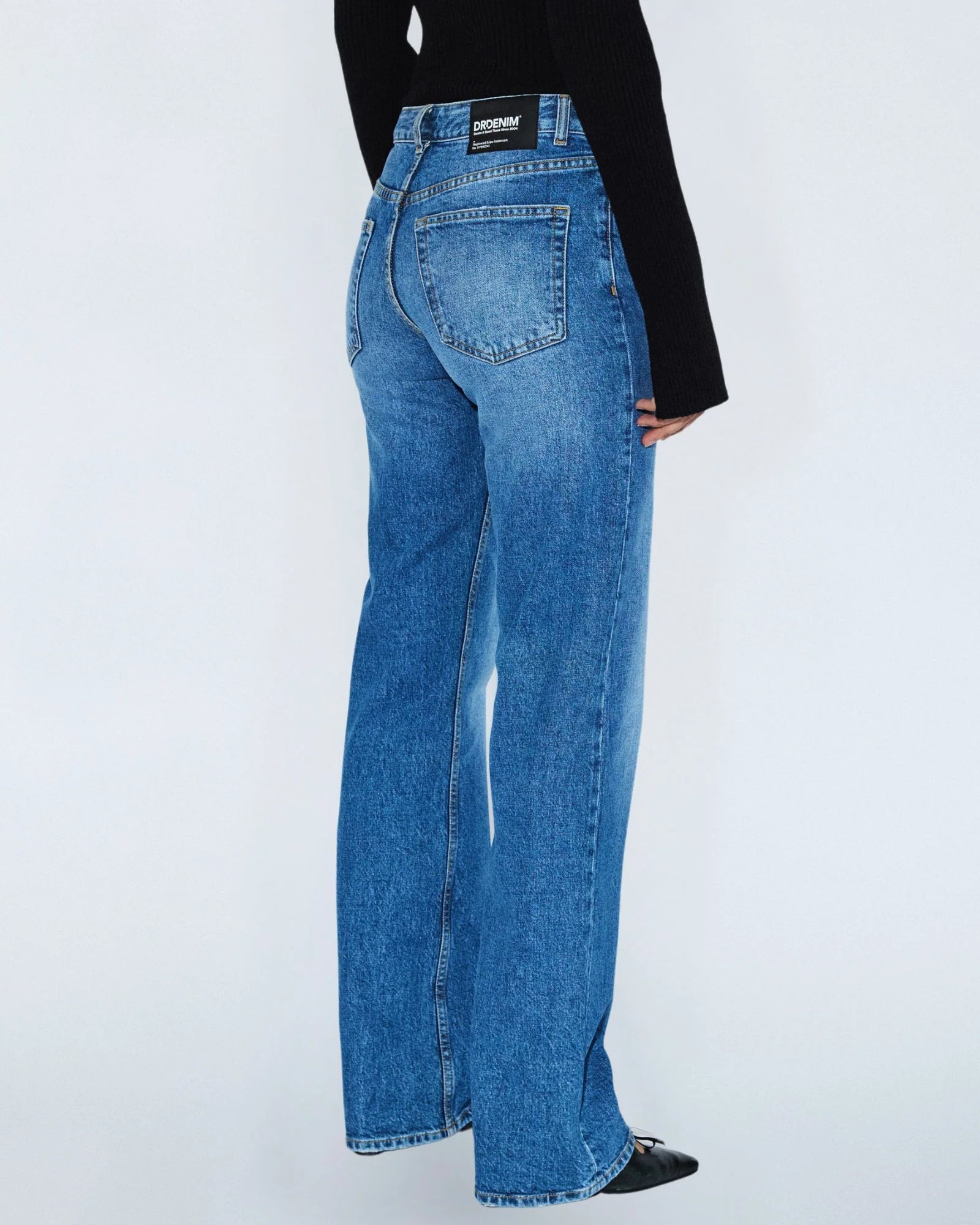 Blue jeans worn by a person on a white background