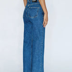 Blue jeans worn by a person on a white background