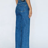 Blue jeans worn by a person on a white background