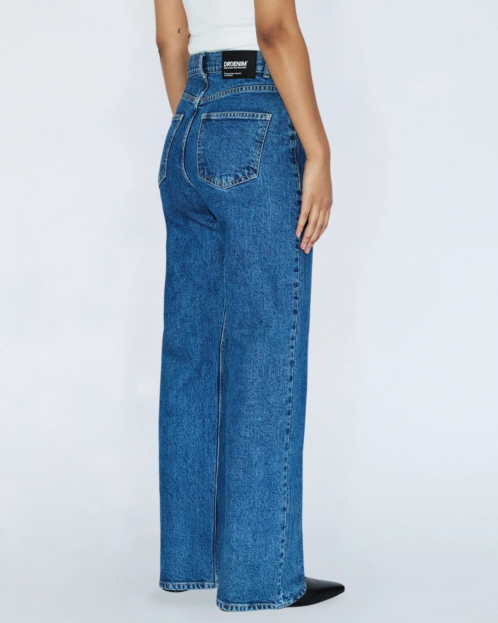 Blue jeans worn by a person on a white background
