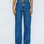 Person wearing blue jeans on a white background