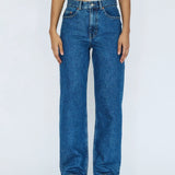 Person wearing blue jeans on a white background