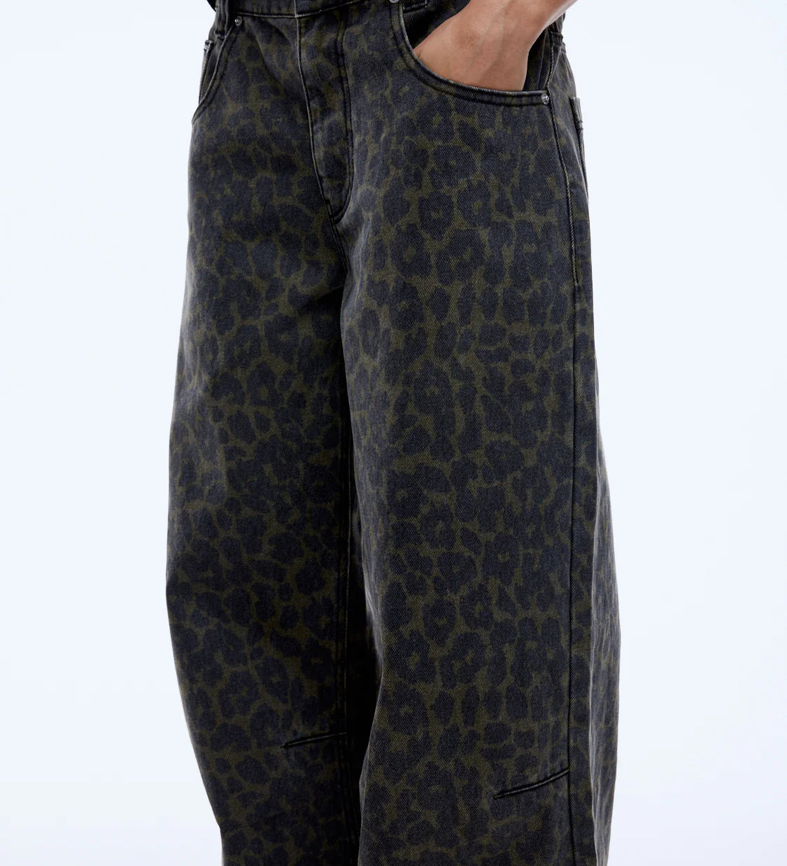 Leopard print pants worn by a person on a white background
