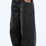 Leopard print pants worn by a person on a white background