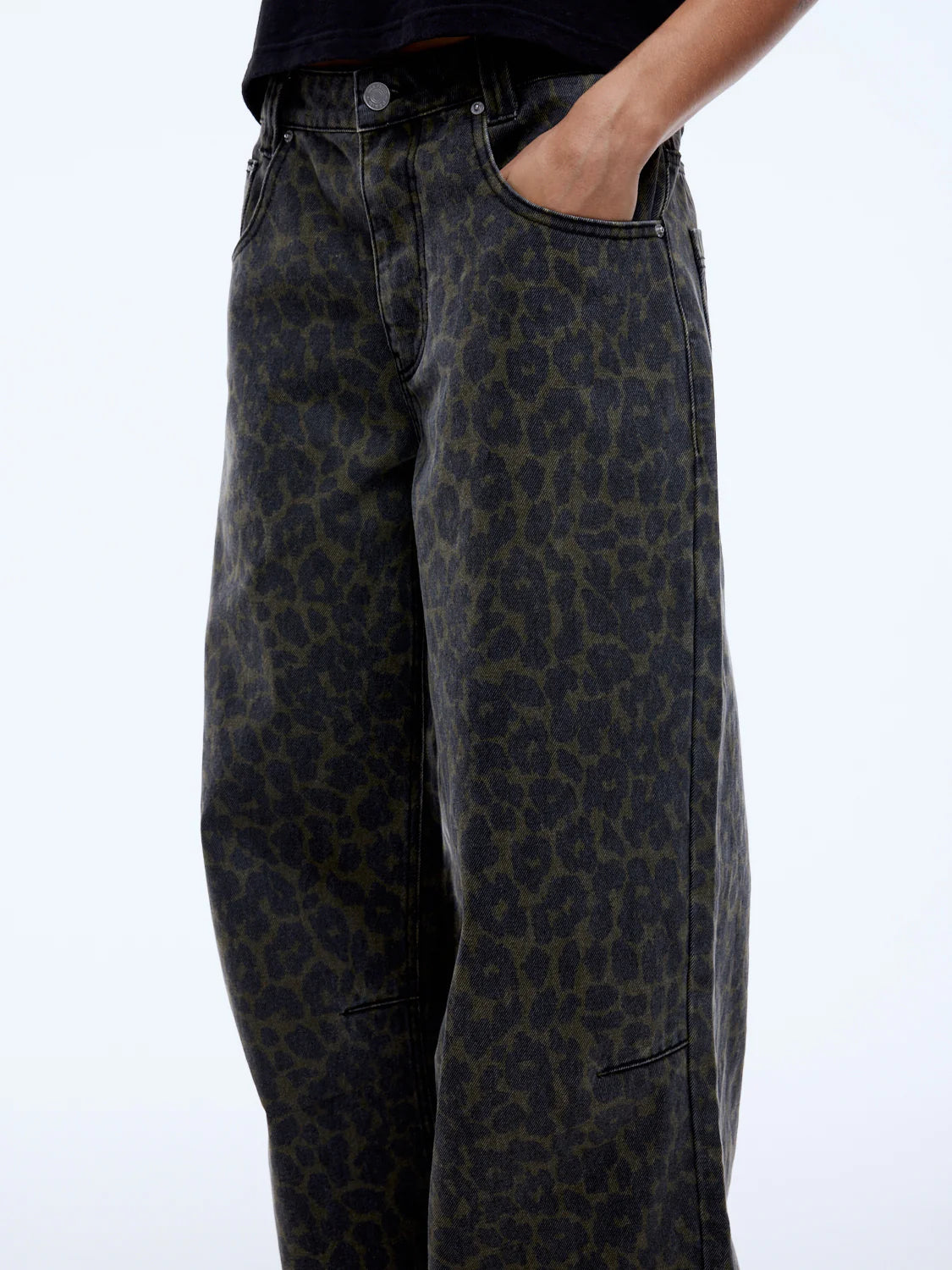 Leopard print pants worn by a person on a white background