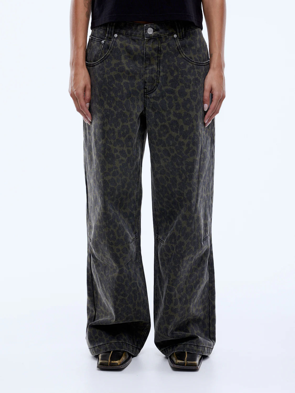 Person wearing leopard print jeans on a white background