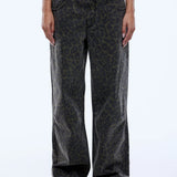 Person wearing leopard print jeans on a white background