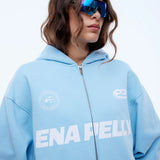 Person wearing a light blue hoodie with 'ENAPELLY' branding on a white background