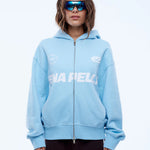 Person wearing a light blue hoodie with a brand logo on a white background