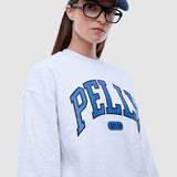 Person wearing a white sweatshirt with 'PELLY' branding and a blue cap.