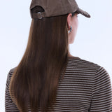 Person wearing a brown cap and striped shirt with long hair, on a white background
