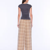 A woman shown from the back wearing a dark gray short-sleeve top and beige plaid wide-leg pants against a plain white studio background.
