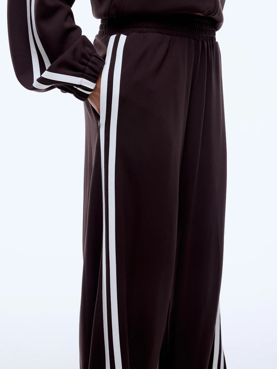 Brown tracksuit with white stripes on a light gray background