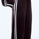 Brown tracksuit with white stripes on a light gray background