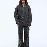 Person wearing a dark gray outfit on a white background