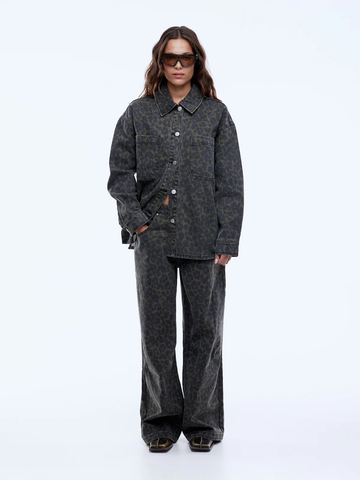 Person wearing a dark gray outfit on a white background