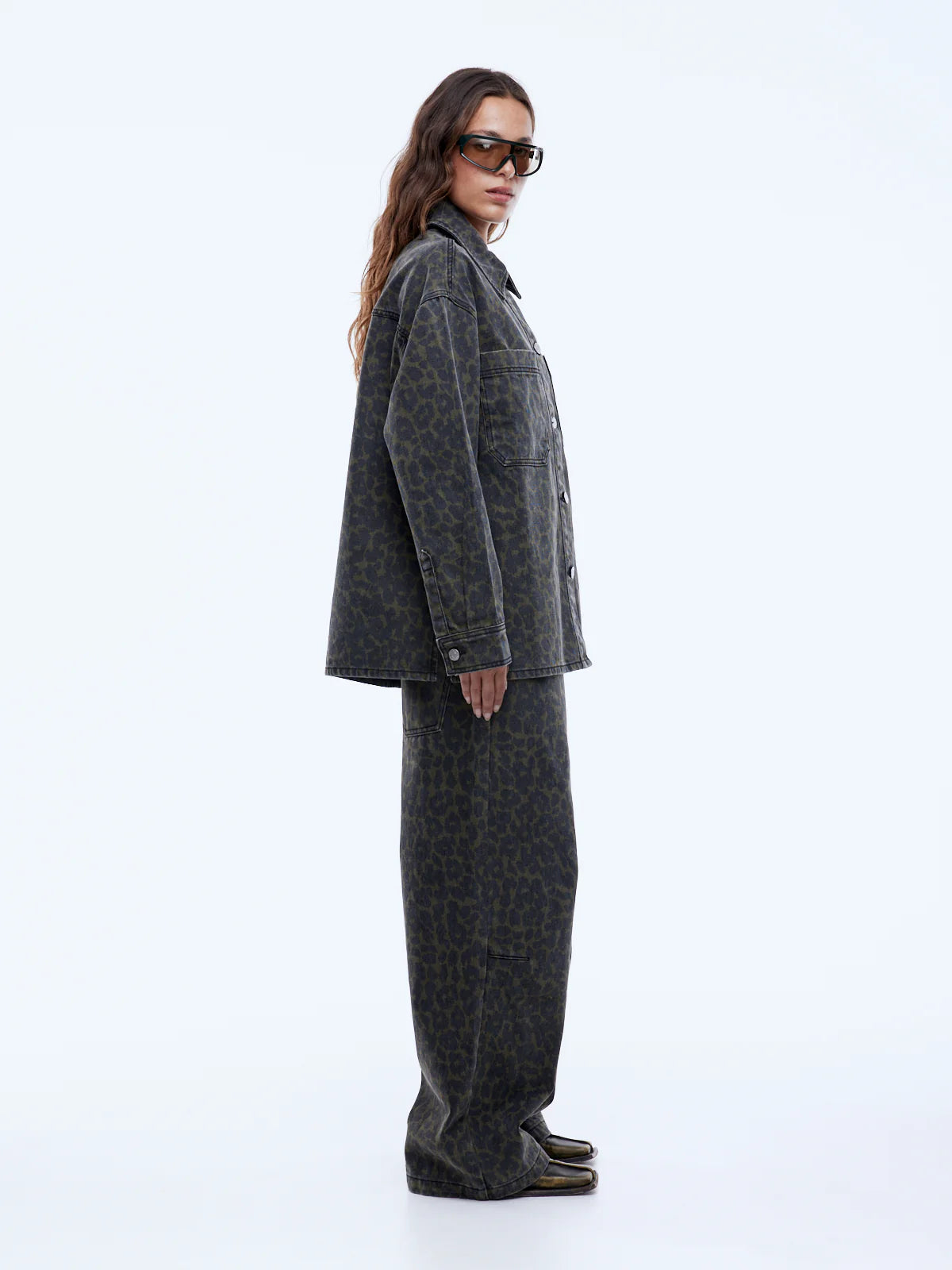 Woman wearing a gray coat and pants on a white background