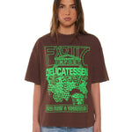 Person wearing a brown t-shirt with green graphic design on a white background