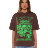 Person wearing a brown t-shirt with green graphic design on a white background