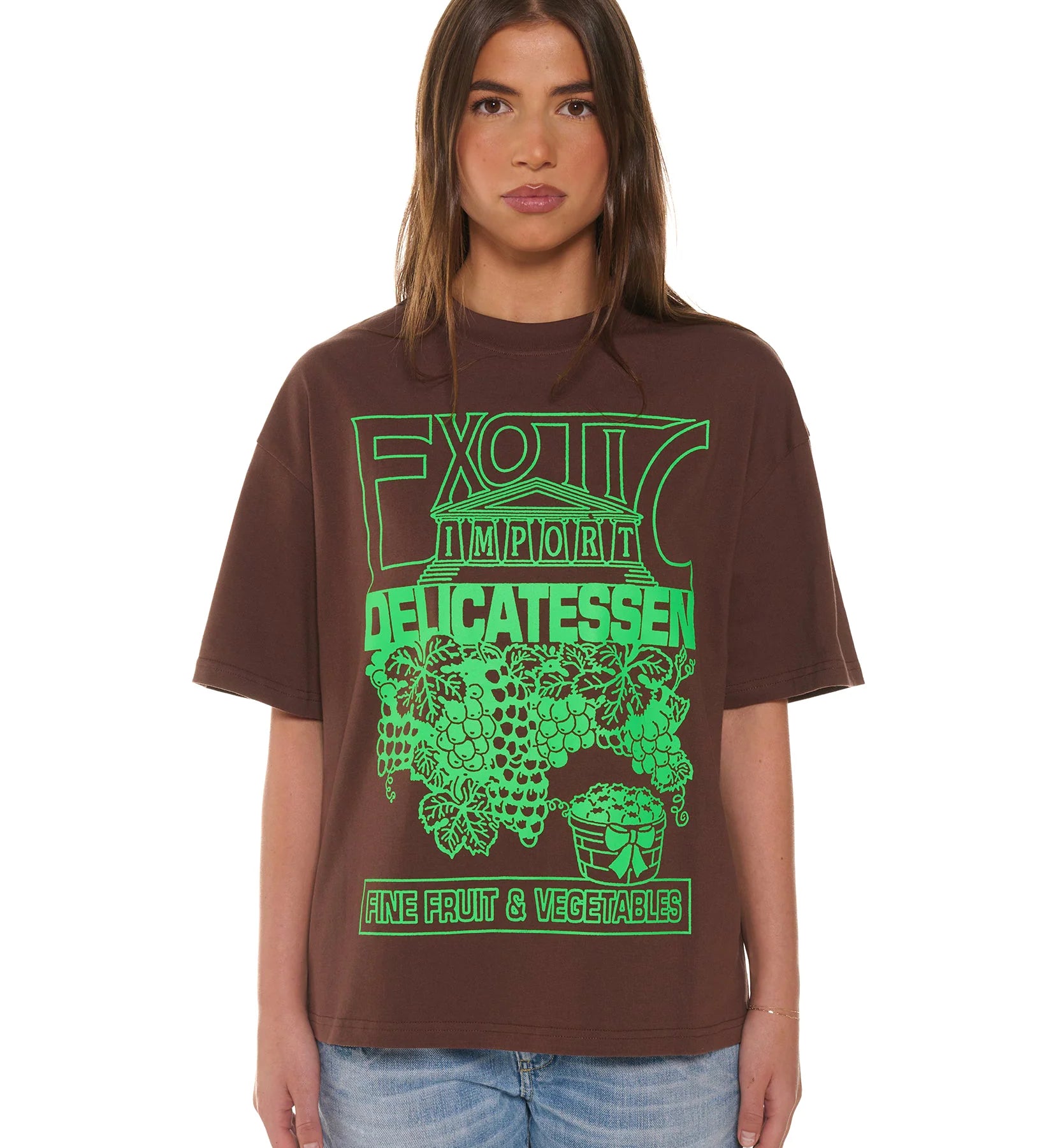 Person wearing a brown t-shirt with green graphic design on a white background