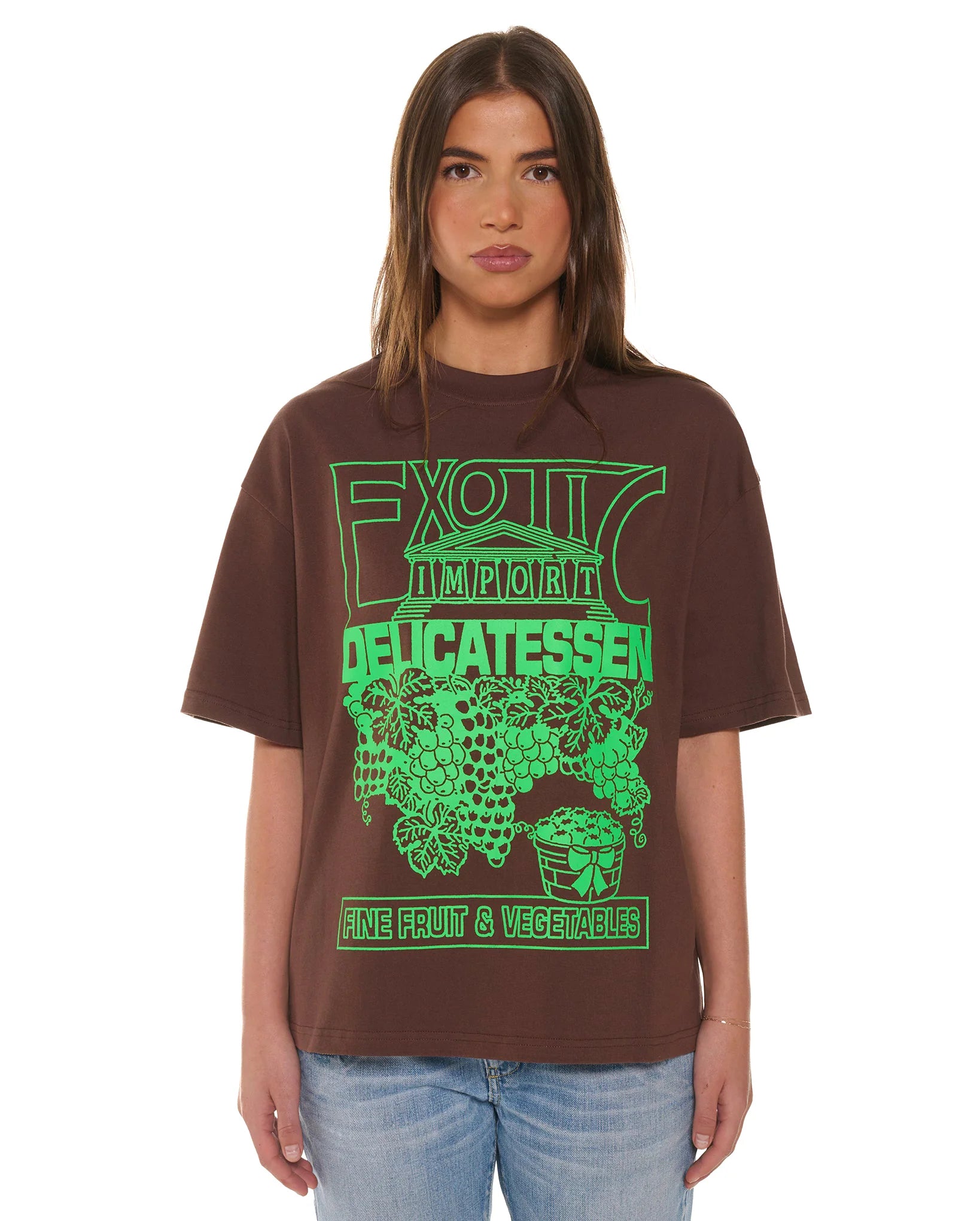 Person wearing a brown t-shirt with green graphic design on a white background