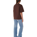 Person wearing a brown t-shirt and blue jeans on a white background