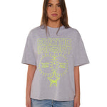 Person wearing a gray t-shirt with yellow text and graphics on a white background