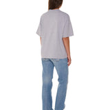 Person wearing a gray t-shirt and blue jeans on a white background