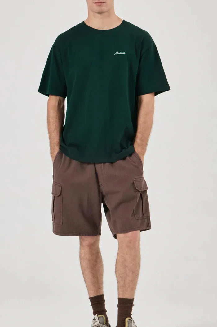 Person wearing a green t-shirt and brown cargo shorts on a white background