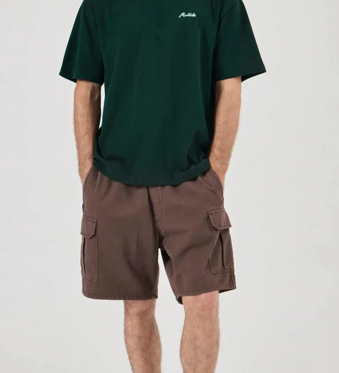 Person wearing a green t-shirt and brown cargo shorts on a white background