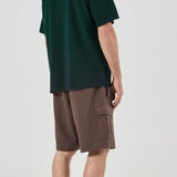Person wearing a green t-shirt and brown shorts on a white background