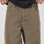 Olive cargo shorts worn by a person on a white background