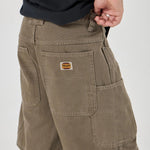 Person wearing Olive shorts with a visible brand logo on a white background