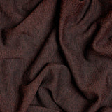 A close-up of draped dark brown fabric with a soft, textured weave and subtle sheen.