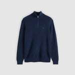 Navy blue half-zip sweater on a light gray background