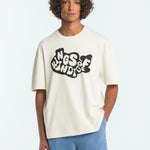 Person wearing a white t-shirt with black text and blue pants on a light gray background