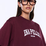 Person wearing a maroon t-shirt with 'ENAPELLY' branding on a white background