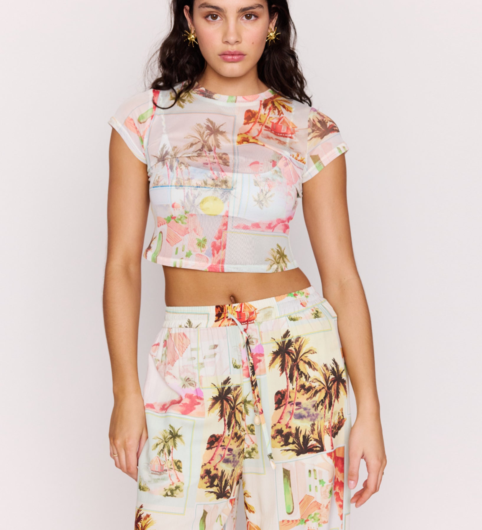 Woman wearing a floral outfit with a white background