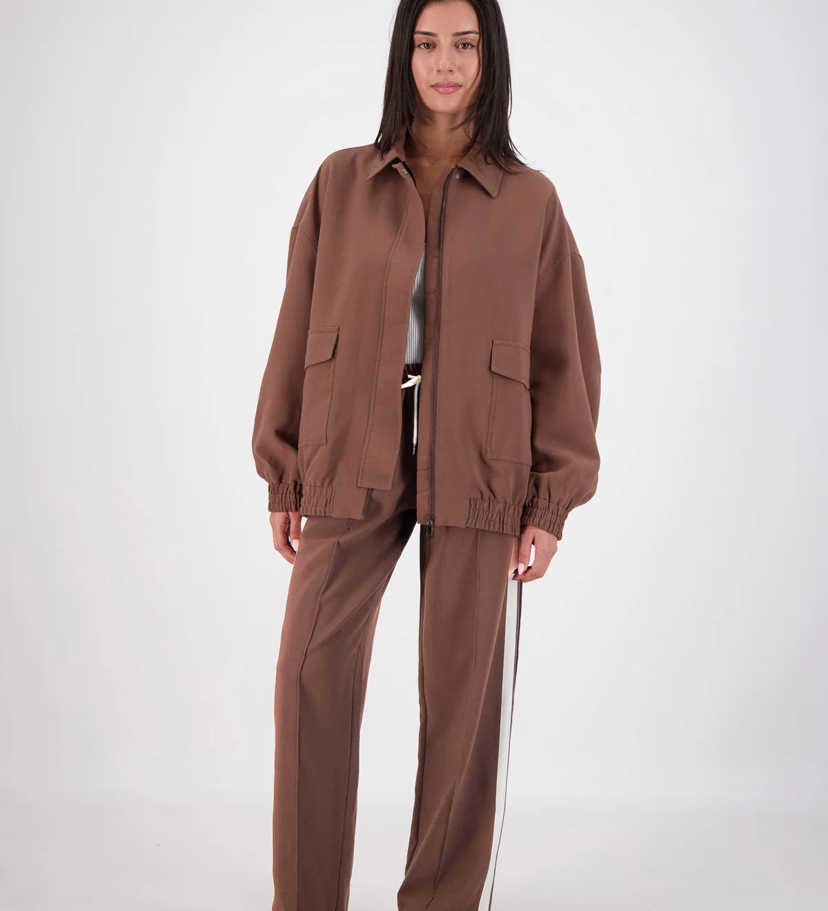 Person wearing a brown outfit on a white background