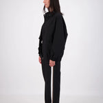 Person wearing a black outfit on a white background