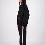 Person wearing a black outfit on a white background