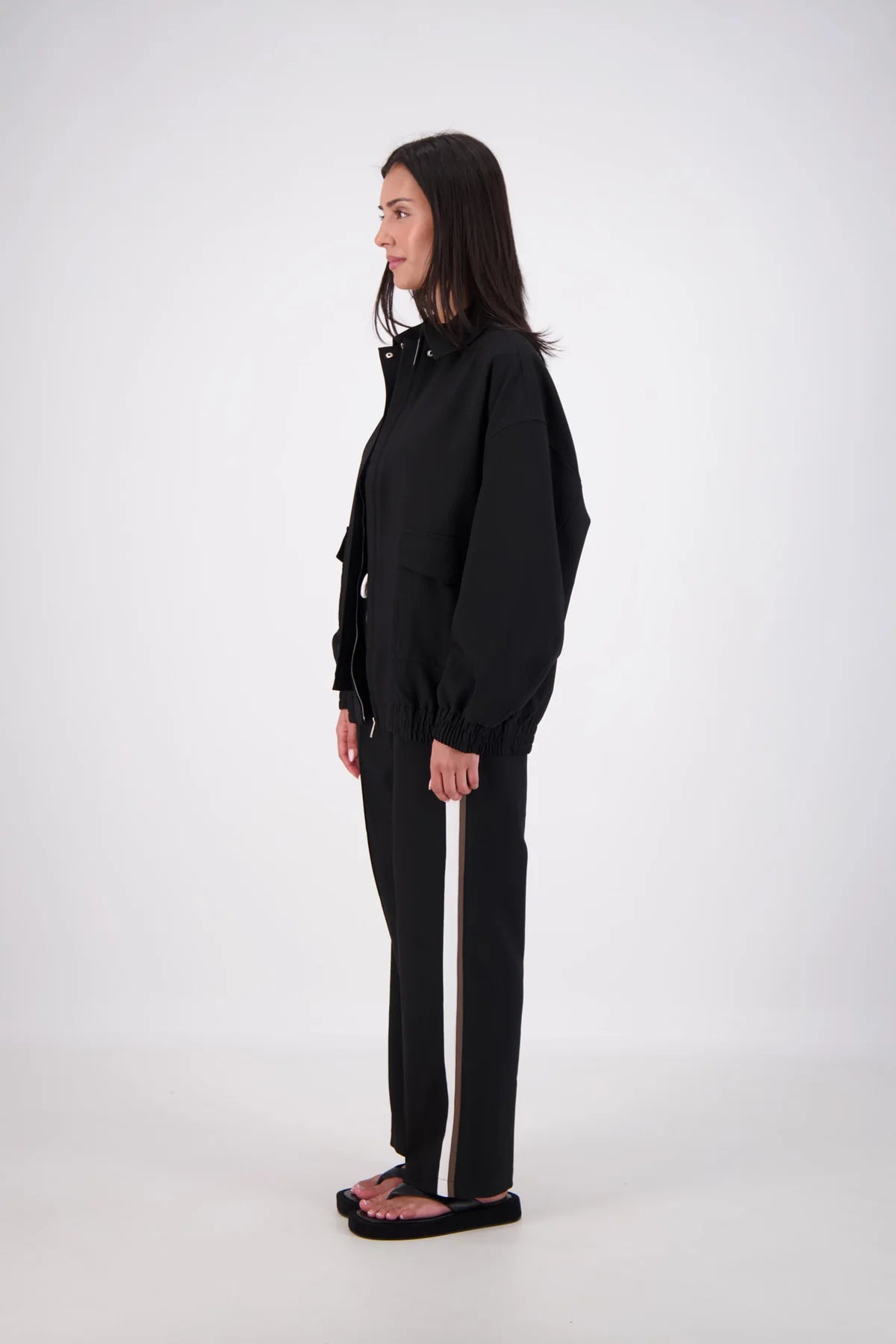 Person wearing a black outfit on a white background