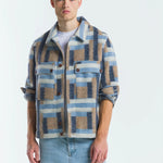 Man wearing a plaid shirt over a white t-shirt with light blue jeans on a white background