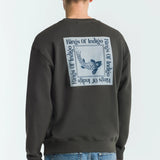 Person wearing a dark grey sweatshirt with 'Rings of Indigo' logo on the back, standing against a white background.