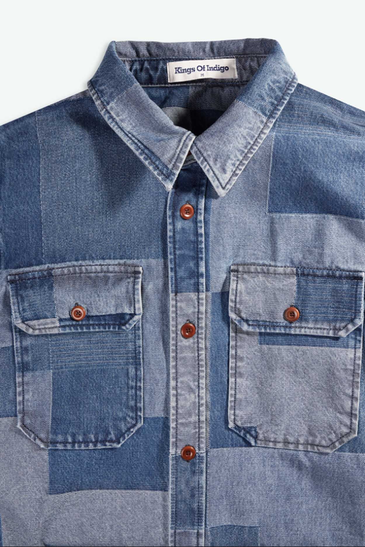 Blue denim shirt with patchwork pattern and button details, brand 'Kingdom of Indigo' visible.
